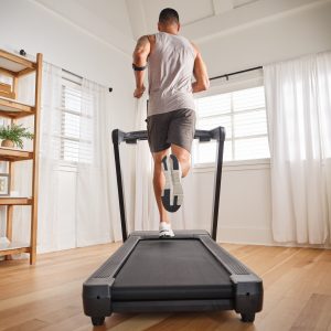 Beginner walking on a NordicTrack treadmill at home, restarting fitness journey with supportive cushioning and iFIT training.