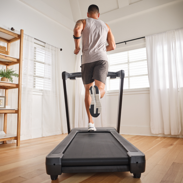 Beginner walking on a NordicTrack treadmill at home, restarting fitness journey with supportive cushioning and iFIT training.