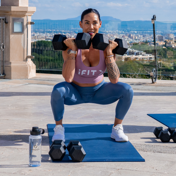 Group strength workout led by iFIT trainers, showcasing accessible dumbbell routines that help protect muscle during GLP-1 weight loss.