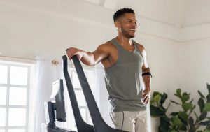 Man exercising on a NordicTrack treadmill at home during a heart health focused workout