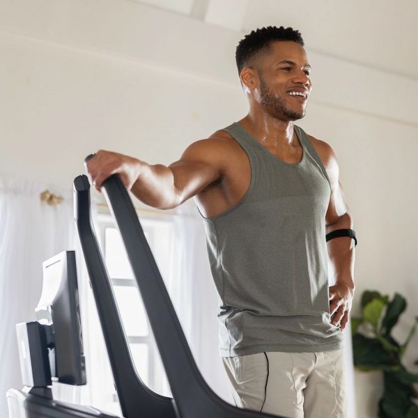 Man exercising on a NordicTrack treadmill at home during a heart health focused workout